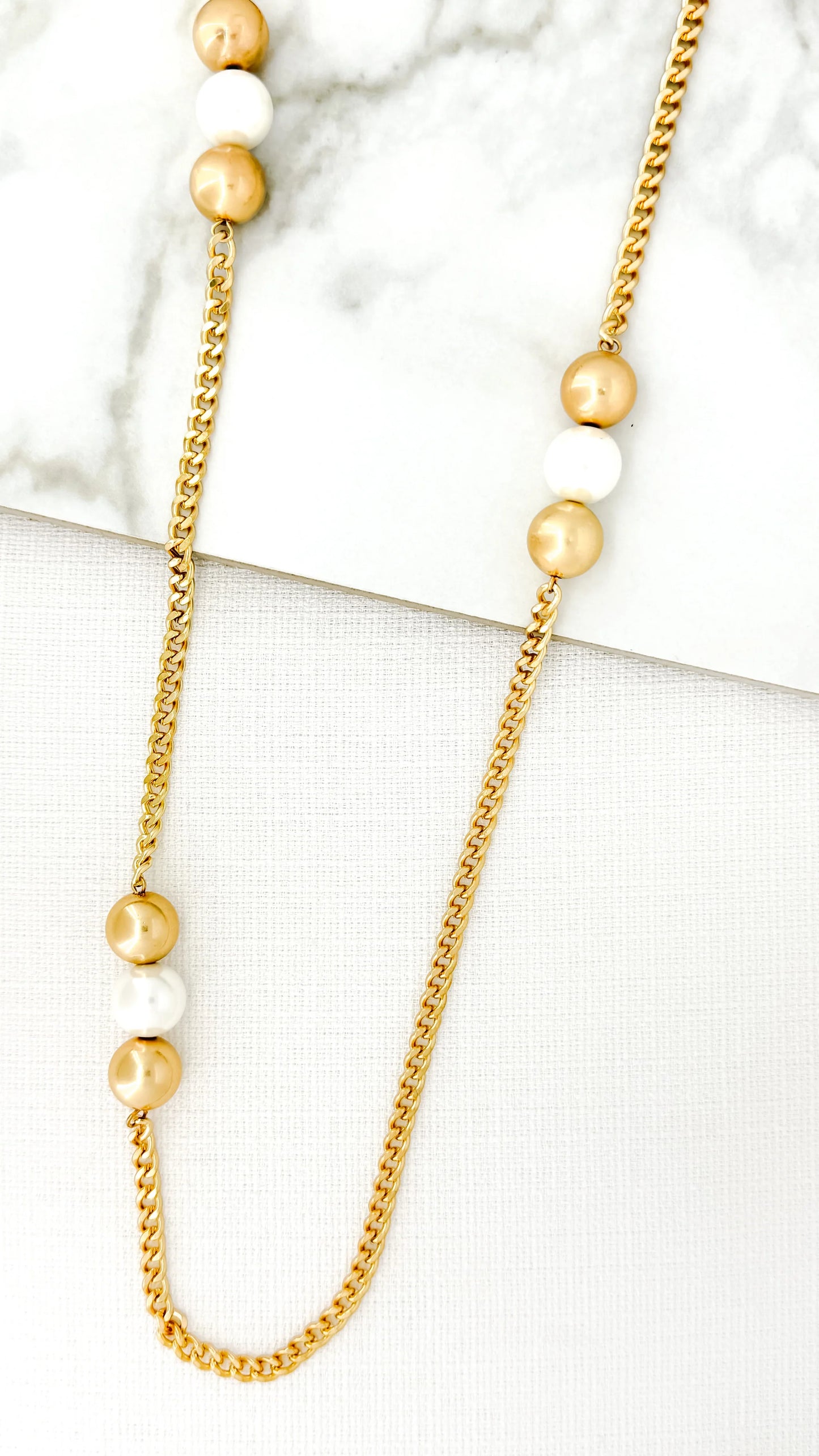Long gold necklace with gold and pearl balls