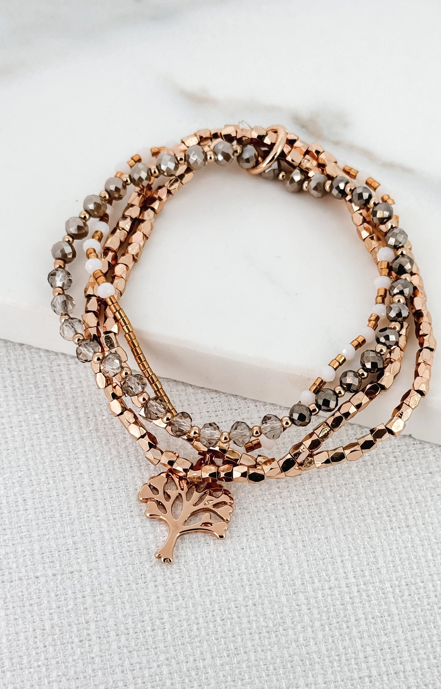Delicate layered gold and grey bead charm bracelet