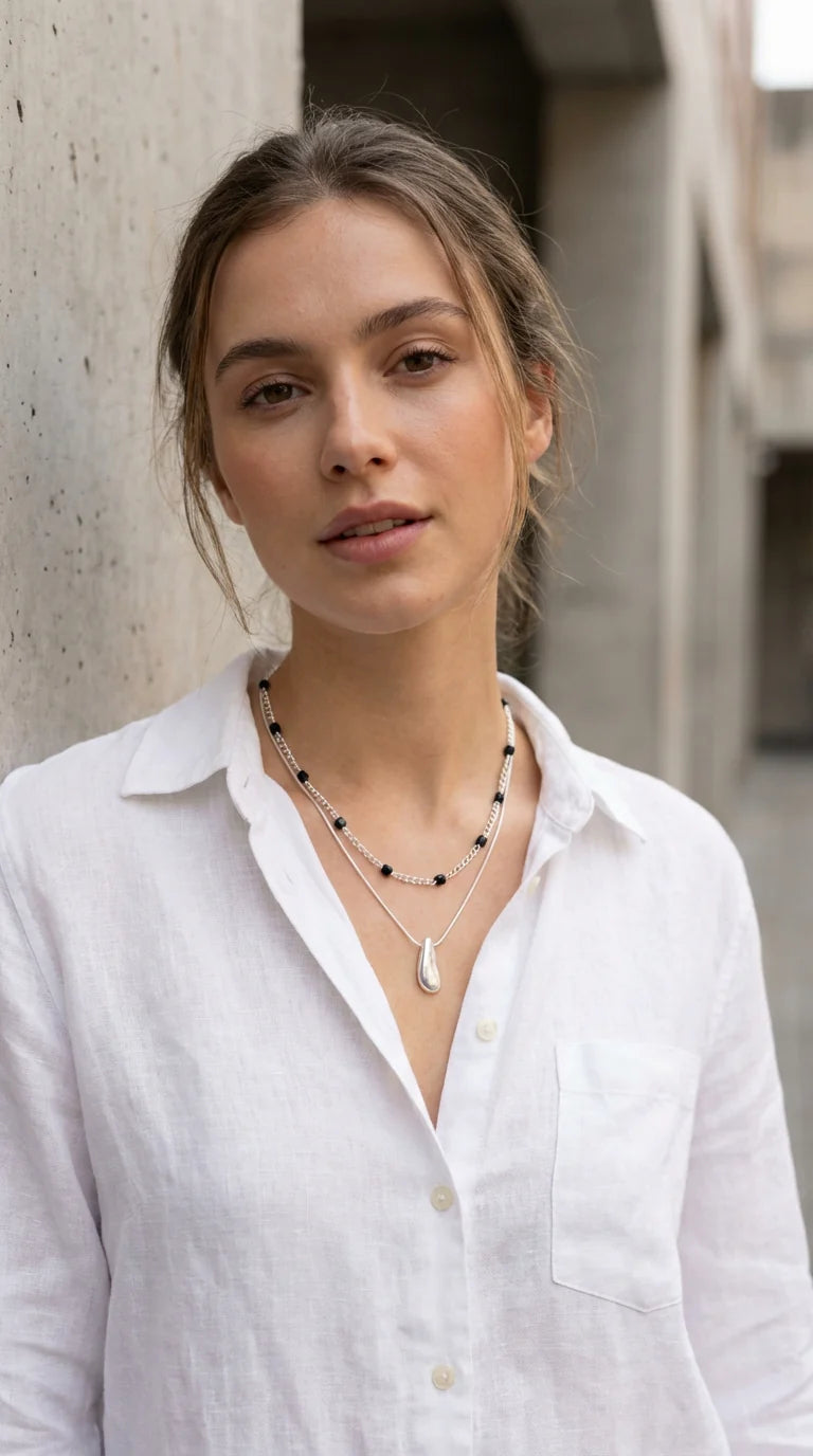 Short silver double layer necklace with grey crystals and a chunky pebble pendant