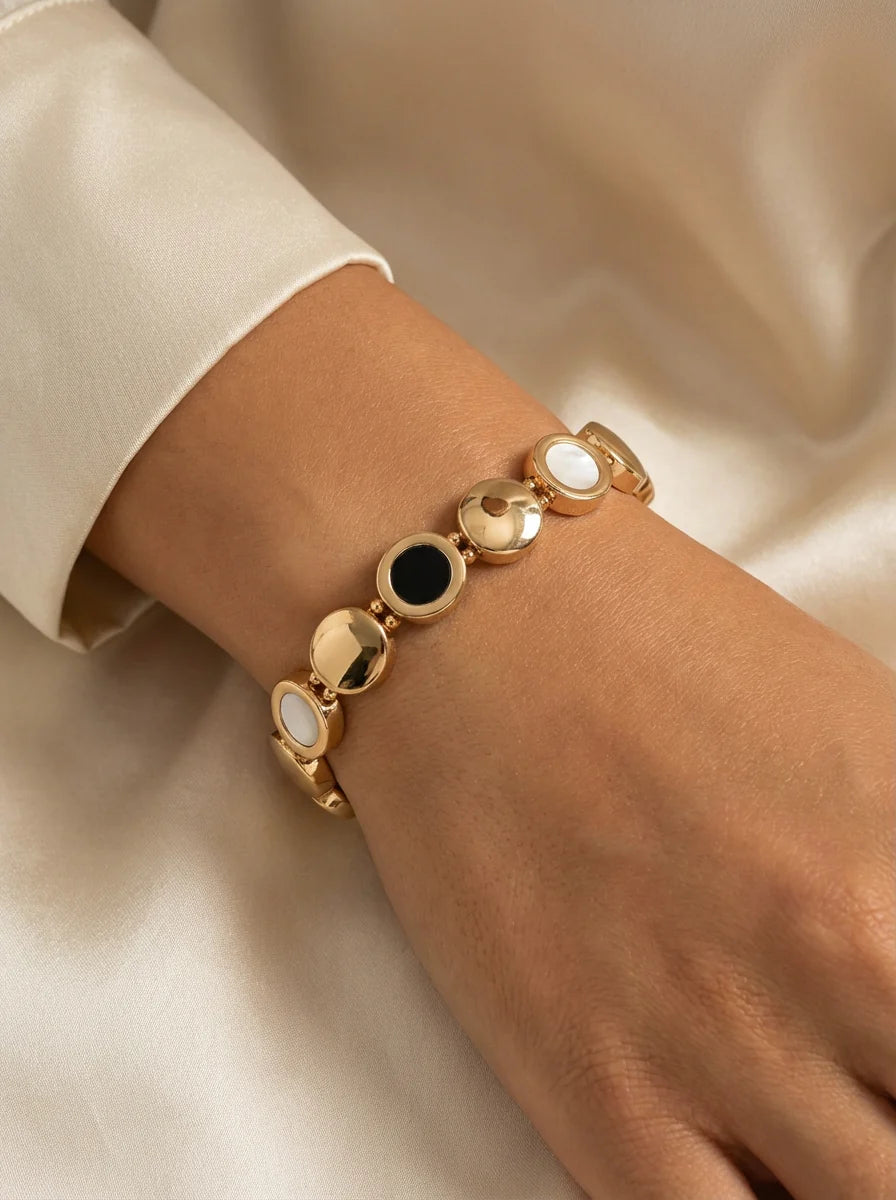 Gold elasticated circles bracelet with black and white detail