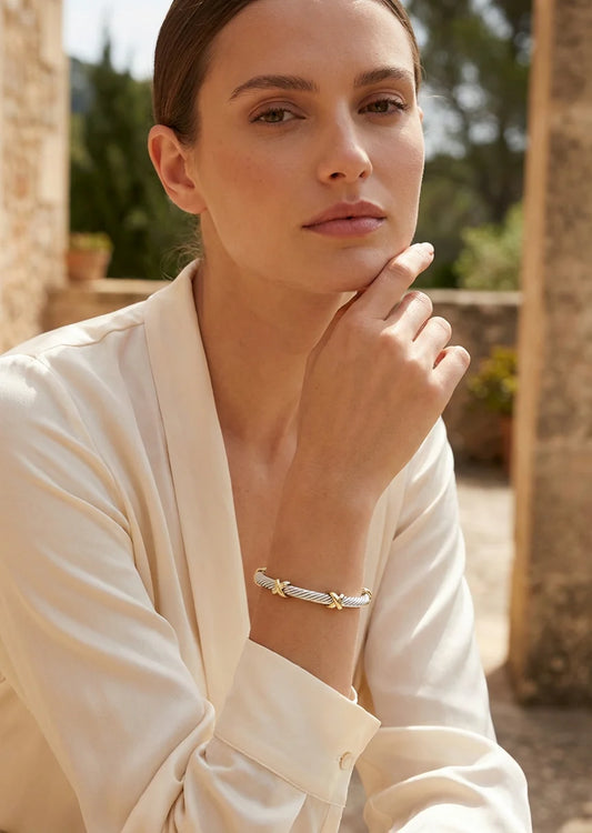 Textured silver and gold two tone bangle with kiss design
