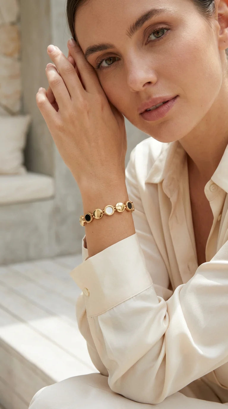 Gold elasticated circles bracelet with black and white detail